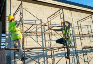 Construction workers assembling scaffolding system safely on building exterior in Berkeley