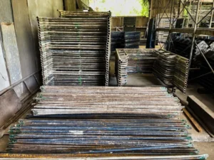 Large stack of scaffolding frames and planks stored in warehouse ready for delivery to Berkeley job sites