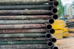 Close-up of stacked scaffolding pipes and metal equipment ready for rental and construction use