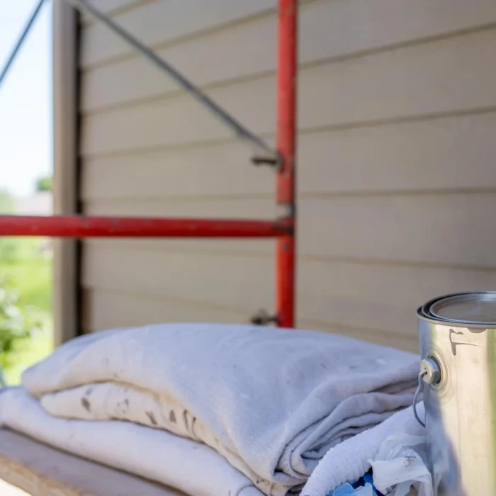 Scaffolding platform with tools and materials ready for construction or painting work
